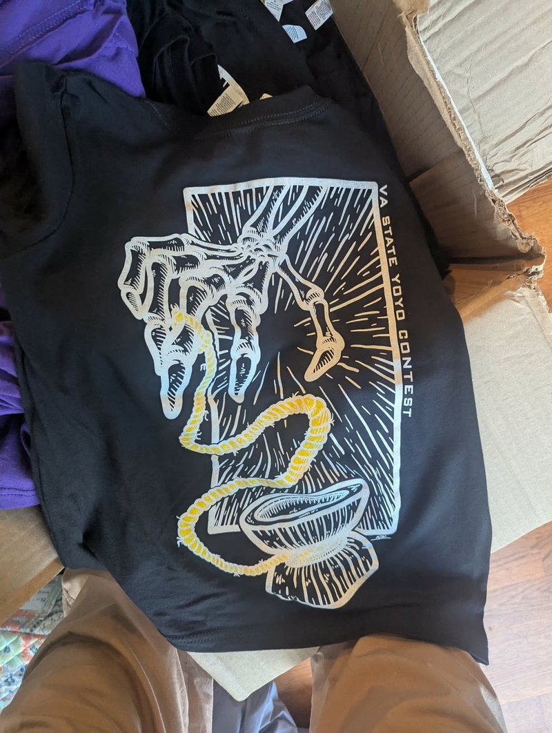 Black t-shirt with a large screen-printed design of a skeletal hand throwing a yo-yo, VA State Yo-Yo Contest