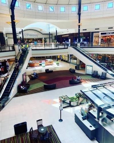 Mall interior with escalators and open atrium